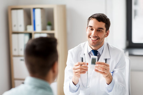 Doctor speaking to patient about a glucose monitor